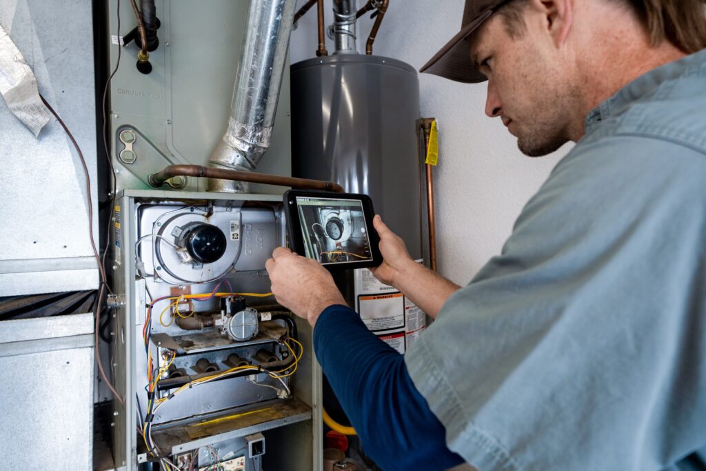 HVAC technician inspecting residential furnace